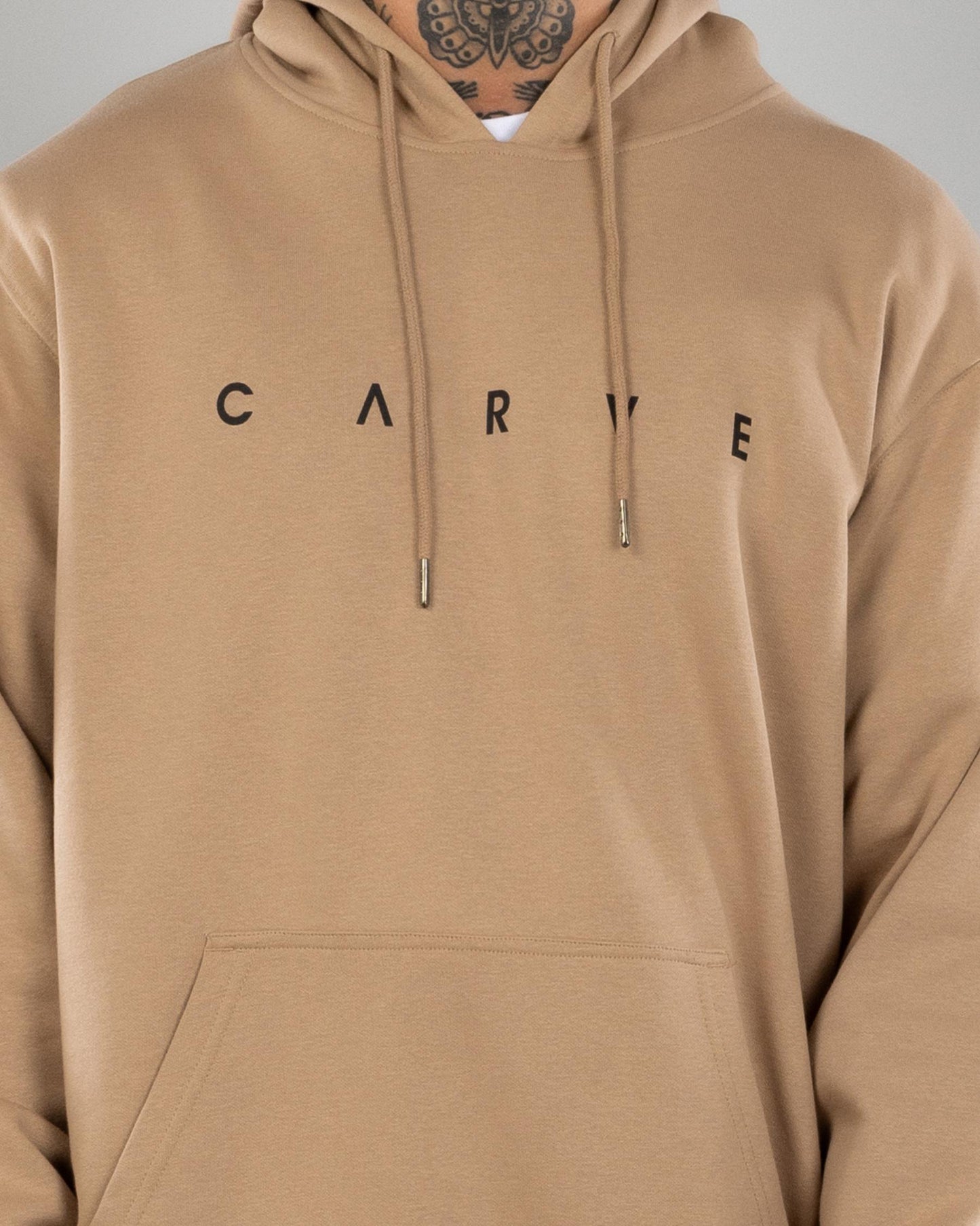 Carve Legacy Men's Pullover Hoodie – caramel hoodie with Carve graphic print on chest closeup