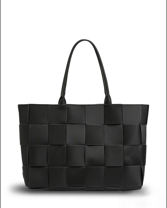 "Side angle of black Prene Holiday Woven Tote showing structured design and textured surface"