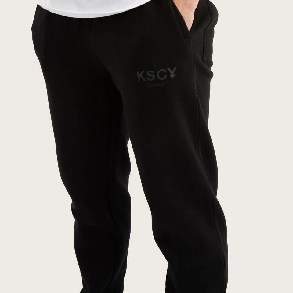 Side angle of Kiss Chacey Brea Trackpant showing pockets and logo in black