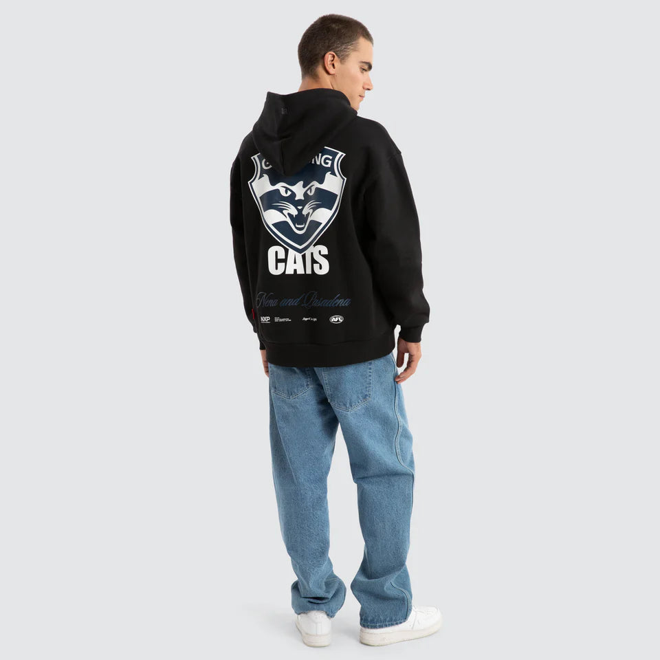 Person wearing a black hoodie with a logo on the back against a light gray background