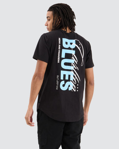 Model showing the back of the NXP Carlton Dual Curved Tee with large "Carlton Blues" vertical graphic and Nena & Pasadena text

