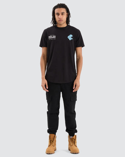 Model wearing the NXP Carlton Dual Curved Tee, featuring Carlton Football Club logo and Nena & Pasadena branding on chest