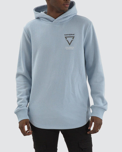 Model wearing NXP Defend Dual Curved Hoodie in Skyway blue with chest logo and curved hem – modern men’s streetwear.